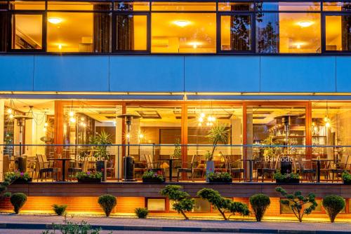 a building with a restaurant with tables and chairs at Kerpė Hotel & SPA in Palanga