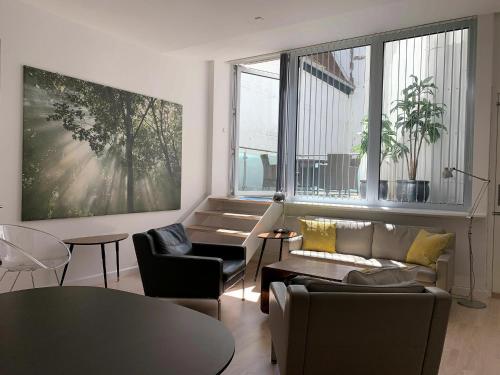 a living room with a couch and chairs and a table at ApartmentInCopenhagen Apartment 358 in Copenhagen