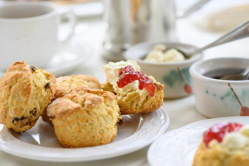 a plate of muffins on a table with a cup of coffee at Killarney Lodge in Killarney