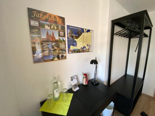 a black desk with a mirror and a dressing table at Ferienwohnung Am Jacobsweg Wohnung 1 in Wurzen
