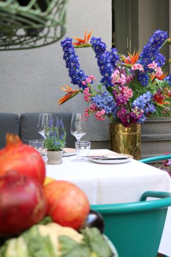 a table with a white table cloth and flowers on it at Hotel AMO by AMANO Friedrichstraße in Berlin