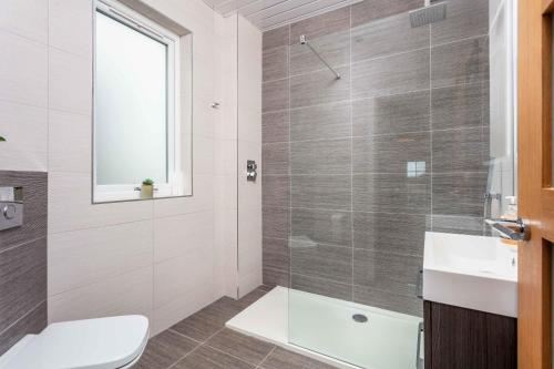 a bathroom with a shower and a toilet and a sink at Rothiemay House - Donnini Deluxe in Prestwick