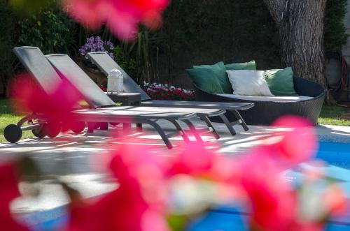 a picnic table with two chairs and a couch at Villa Serenity in Porto Rafti