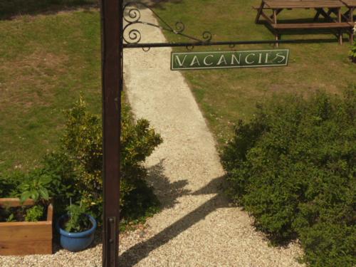 a sign for a park with a bench and a garden at Twin Oaks Guest House in Cadnam
