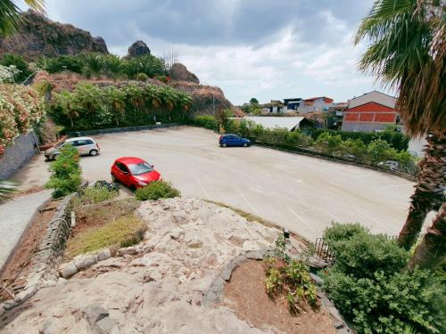 a parking lot with two cars parked in it at Hotel Casale dei Greci in Biancavilla