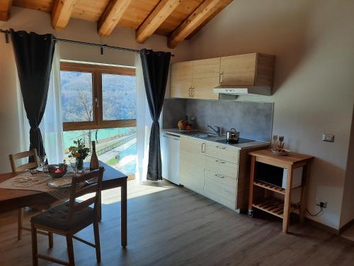 a kitchen with a table and a table and a dining room at Ai Monti in Barcis