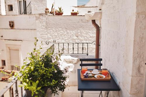 a tray of food on a table on a balcony at 1783 Dimora d'Epoca in Locorotondo
