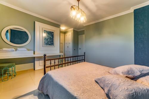 a bedroom with a bed and a bathroom with a mirror at VISTA Villa in Belek