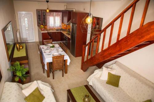 an overhead view of a dining room and kitchen with a table at Vasso's cozy and comfortable apartment in Preveza