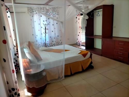 a bedroom with a bed with a canopy at MJ MARINA, Fastcare Mtwapa Creek in Mombasa