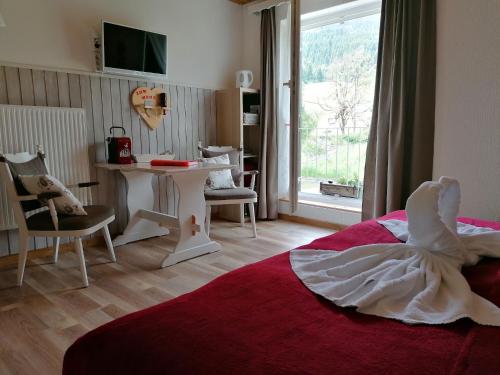 a bedroom with a bed with a dress on it at B&B Haus Holunder Weissbriach in Weissbriach