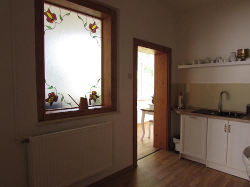a kitchen with a window with a sink and a counter at Bara ház in Tvrdošovce