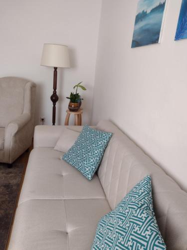a white couch with two pillows on it in a living room at Bara ház in Tvrdošovce
