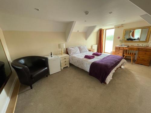 a bedroom with a bed and a chair and a desk at Station House, Dartmoor and Coast located, Village centre Hotel in South Brent