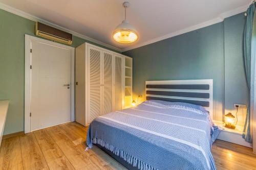 a bedroom with a large bed with blue walls at VISTA Villa in Belek