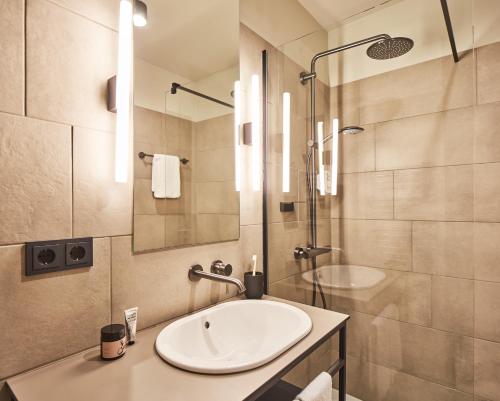 a bathroom with a sink and a shower at hood house in Hamburg