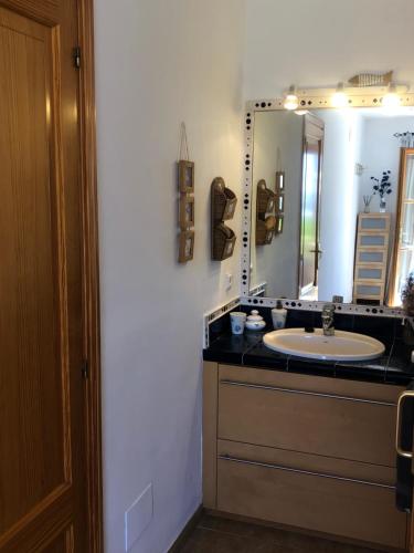 a bathroom with a sink and a mirror at Balco d’es Trenc in Sa Ràpita