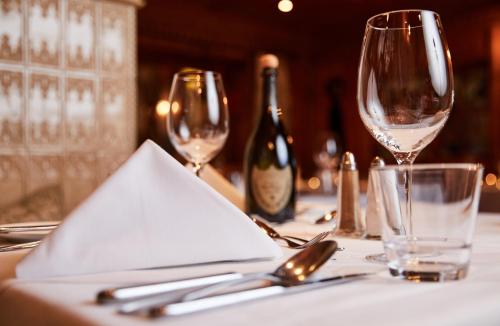 a table with wine glasses and napkins on it at Luxury All Inclusive Resort Schwarzbrunn 4 Sterne Superior in Stans
