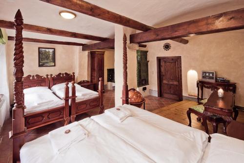 a bedroom with two beds with white sheets at Penzion Baroko in Český Krumlov