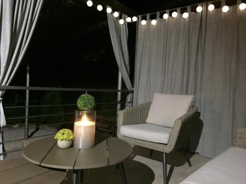 a patio with a candle and a chair and a table at Apartman SONAS 2 with free private parking in Karlovac