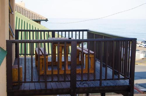 a balcony with a table and chairs and the ocean at Smart Diva Accommodation in East London