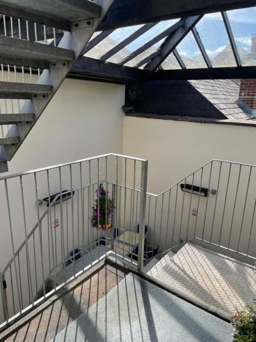 a balcony with a gate with a plant on it at Station House, Dartmoor and Coast located, Village centre Hotel in South Brent