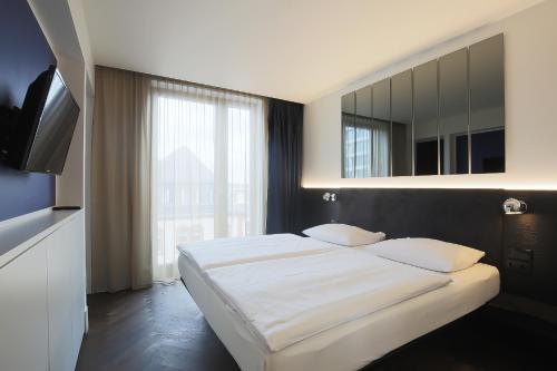 Cama ou camas em um quarto em Hotel AMANO Grand Central