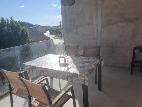 a table and chairs on a balcony with a view at Muring Apartments in Tribunj