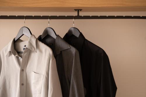a row of shirts hanging on a rack at La Ponta Villas & Suites in Akrotiri