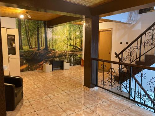 a room with a balcony with a painting on the wall at Casa Adriana in Băile Herculane