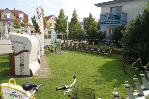 a park with a bunch of bikes parked in the grass at Hotel & Restaurant Hanse Kogge in Ostseebad Koserow