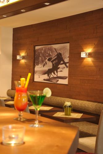 a table with a picture of a horse on the wall at Hotel Unterwirt in Reit im Winkl