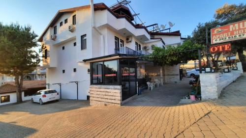 a building on a brick street with a store at Mut Apart Hotel in Fethiye