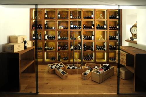 a display case filled with lots of wine bottles at Hotel Unterwirt in Reit im Winkl