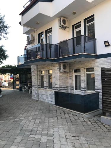a building with balconies and a patio at Mut Apart Hotel in Fethiye