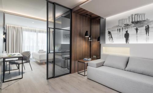 a living room with a couch and a table at Ivis 4 Boutique Hotel in Athens