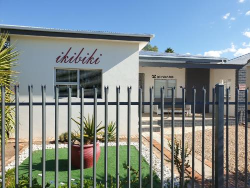 a building with a fence in front of it at ikibiki in Beaufort West