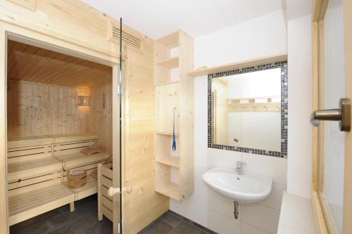 a bathroom with a sink and a shower and a mirror at Adventure Camp in Oetz