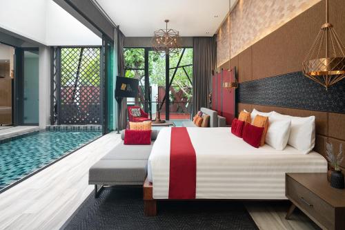 a bedroom with a bed and a swimming pool at The Gems Mining Pool Villas Pattaya in Nong Prue