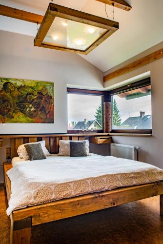a bedroom with a large bed and two windows at Refugio in Tisá