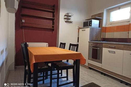 M&M apartman في بودابست: مطبخ مع طاولة وكراسي في مطبخ