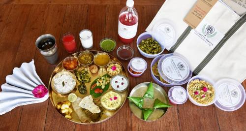 a table with a plate of food on a table at The House of MG-A Heritage Hotel, Ahmedabad in Ahmedabad