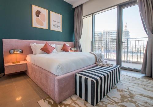 a bedroom with a large bed and a large window at Brand New 2BR in Park Heights 212 in Dubai