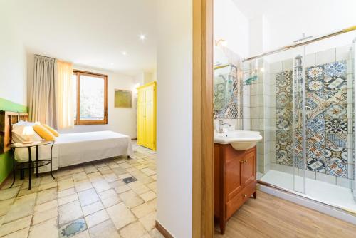 a bathroom with a bed and a shower and a sink at B&B Albachiara Casa di Campagna in Ogliastro Cilento