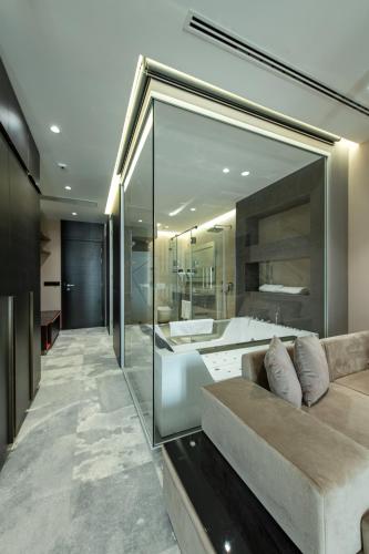 a living room with a couch and a large mirror at Hotel Ženeva Lux in Kragujevac