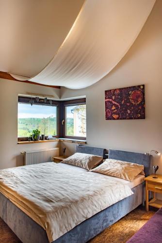 a bedroom with a large bed and a large window at Refugio in Tisá