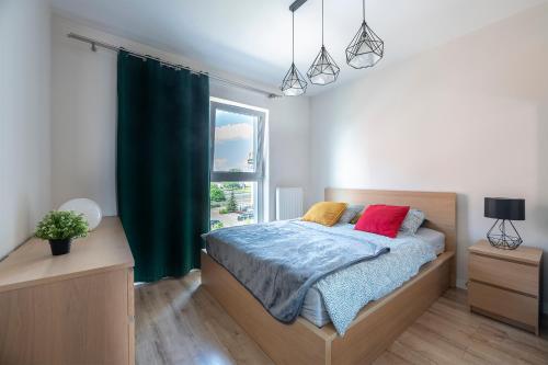 a bedroom with a bed and a window at Luxury in City -1-Bright-Secured-Free Parking in Łódź