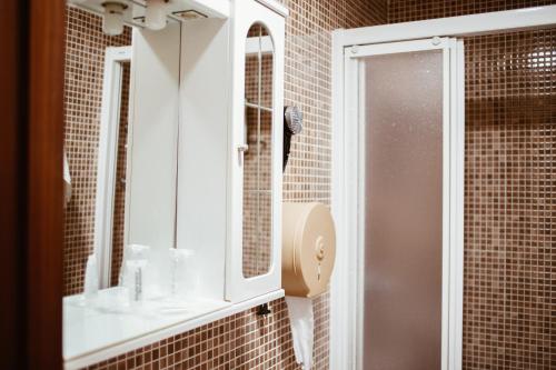 a bathroom with a sink and a mirror at Hostal la Campana in Motril