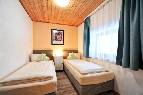 Ένα ή περισσότερα κρεβάτια σε δωμάτιο στο Appartements & Chalets Wiesenruh
