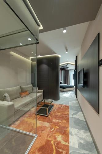 a living room with a couch and a table at Hotel Ženeva Lux in Kragujevac